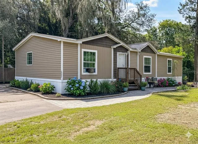 a front view of house with yard and green space