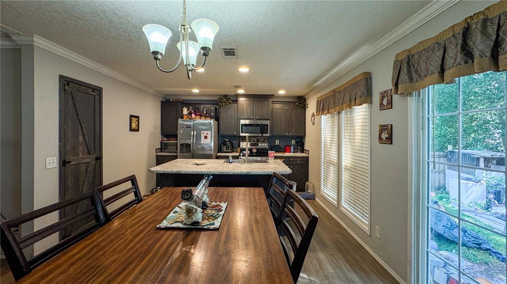 29040 Sentinel Street Nobleton, FL 34661 - Photo 12 of 21 a view of a living room and chandelier with wooden floor