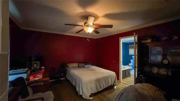 a bedroom with a bed and a chandelier