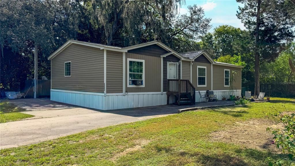 29040 Sentinel Street Nobleton, FL 34661 - Photo 18 of 21 a view of a house with a yard and large tree
