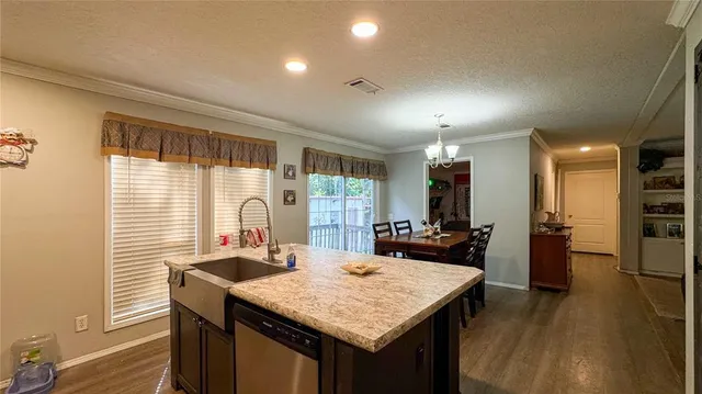 a view of a kitchen area with furniture and wooden floor