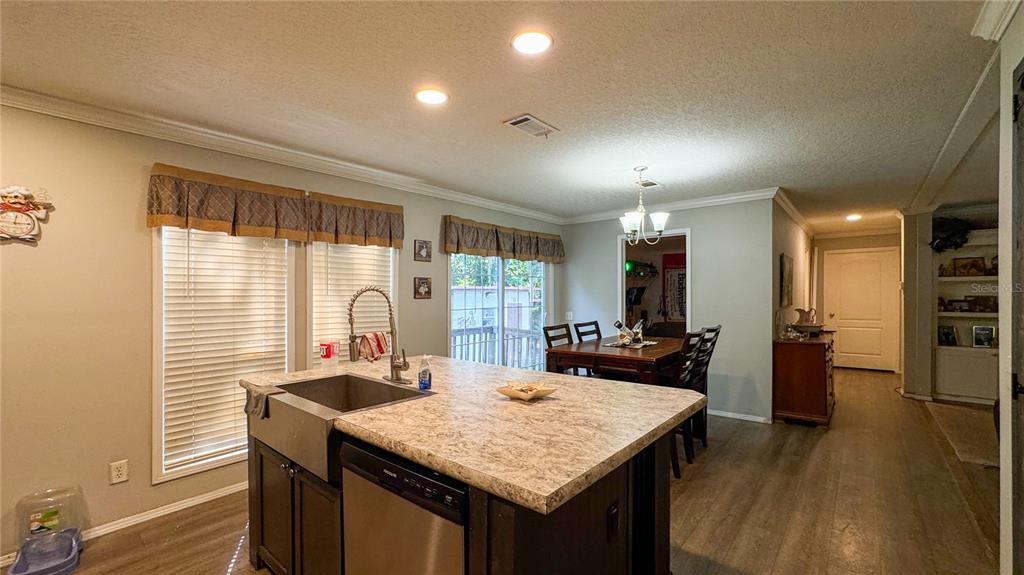 29040 Sentinel Street Nobleton, FL 34661 - Photo 4 of 21 a view of a kitchen area with furniture and wooden floor