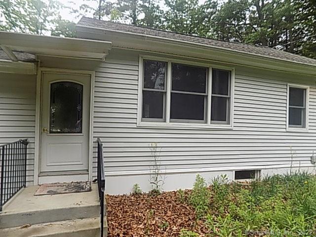 a view of a house with a door and a large window