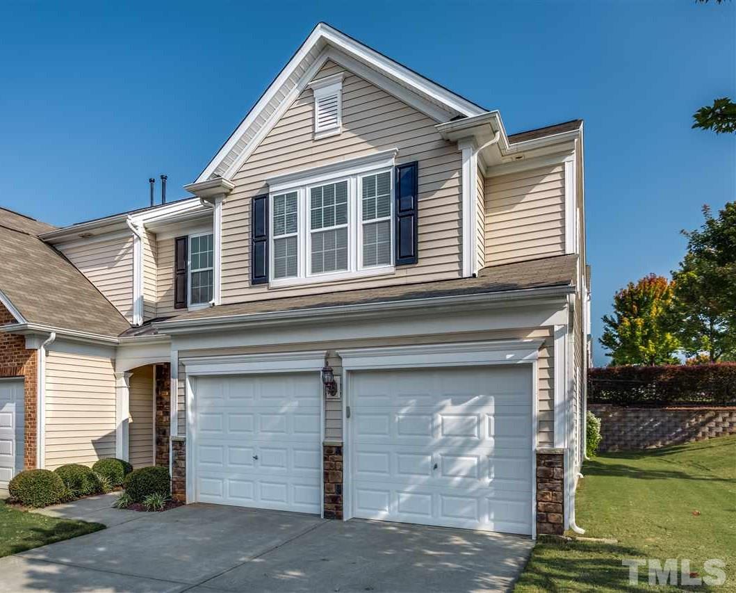 8702 Braxwood Place Raleigh, NC 27617 - Photo 1 of 24 a front view of a house with a yard
