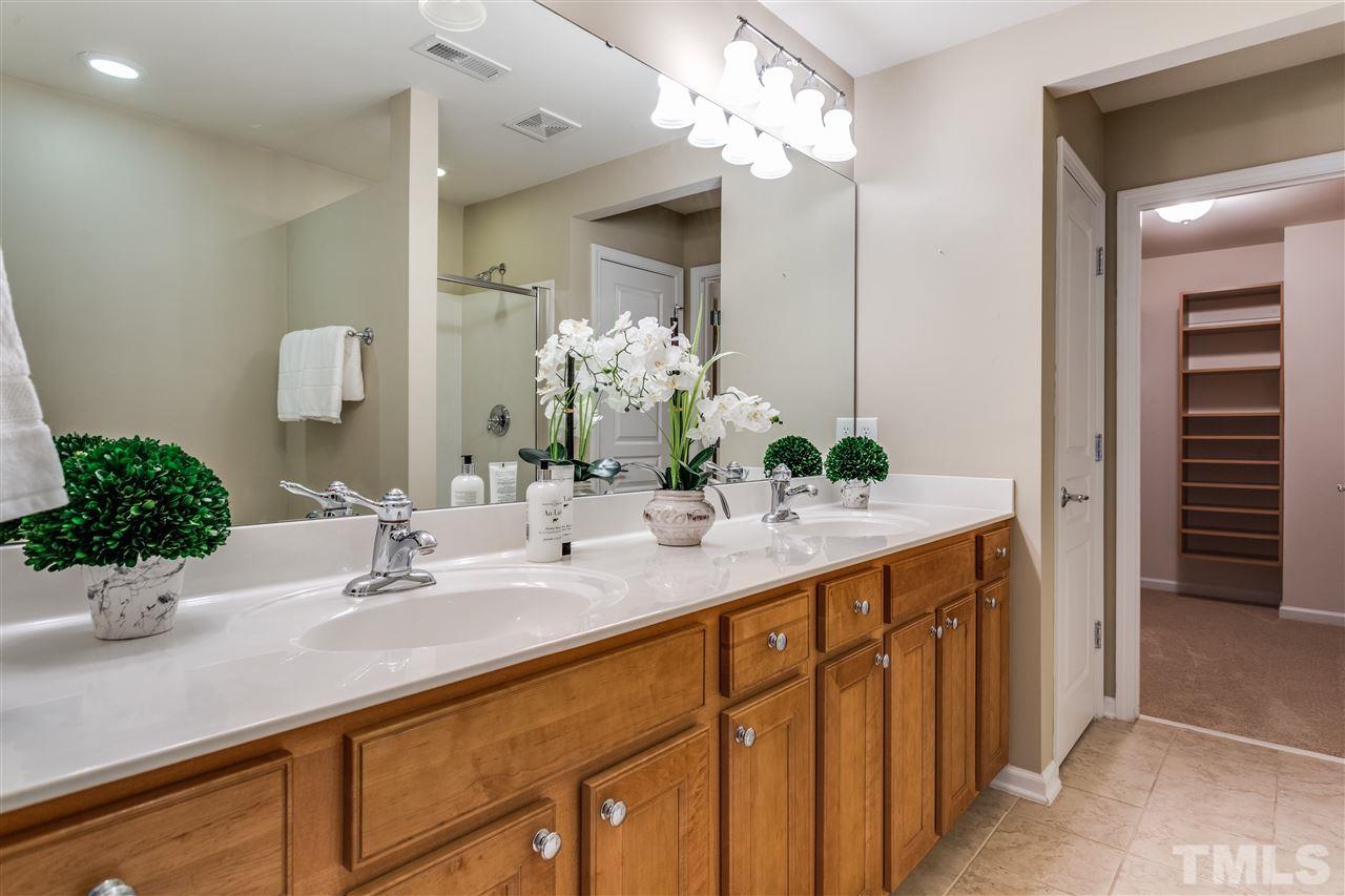 8702 Braxwood Place Raleigh, NC 27617 - Photo 15 of 24 a bathroom with a sink double vanity and a mirror