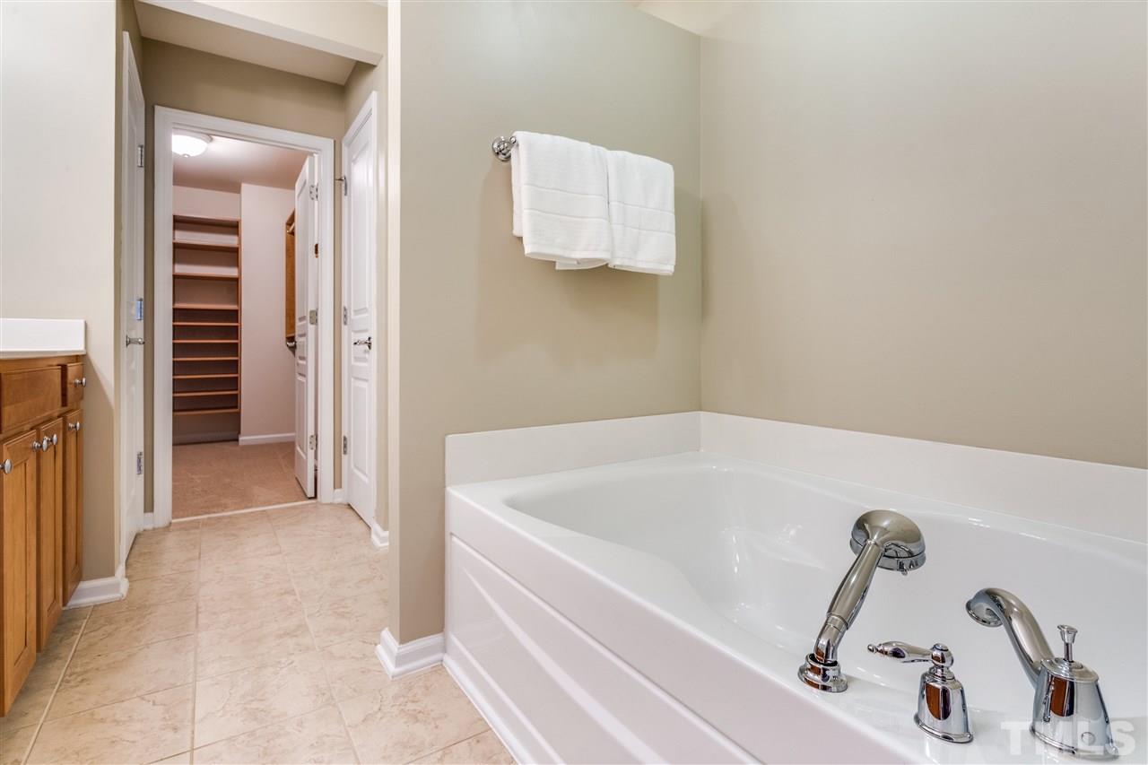 8702 Braxwood Place Raleigh, NC 27617 - Photo 16 of 24 a bathroom with a tub