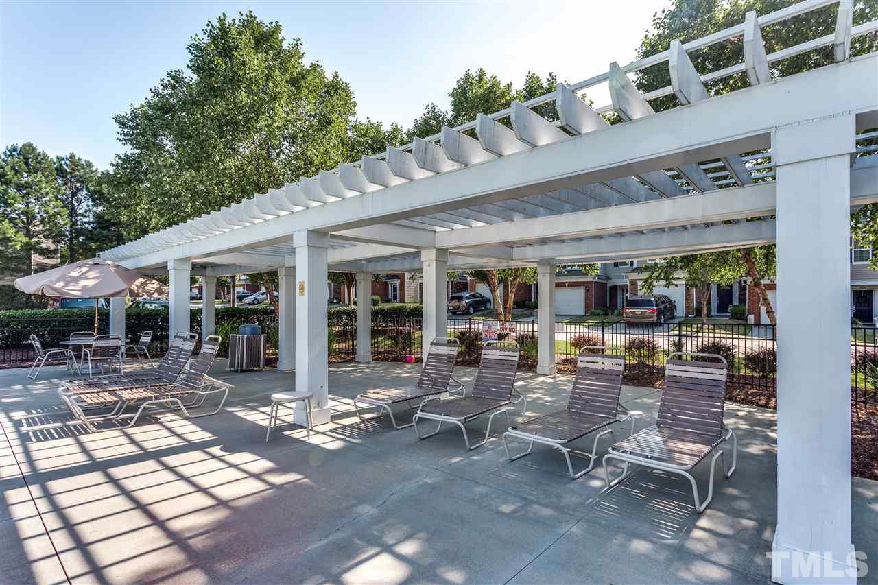 8702 Braxwood Place Raleigh, NC 27617 - Photo 24 of 24 a building outdoor space with patio furniture and potted plants