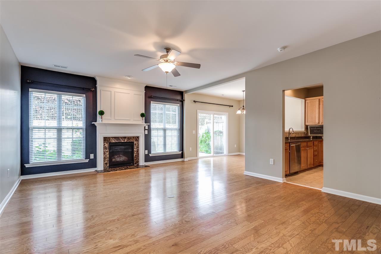 8702 Braxwood Place Raleigh, NC 27617 - Photo 4 of 24 a view of an empty room with window and wooden floor