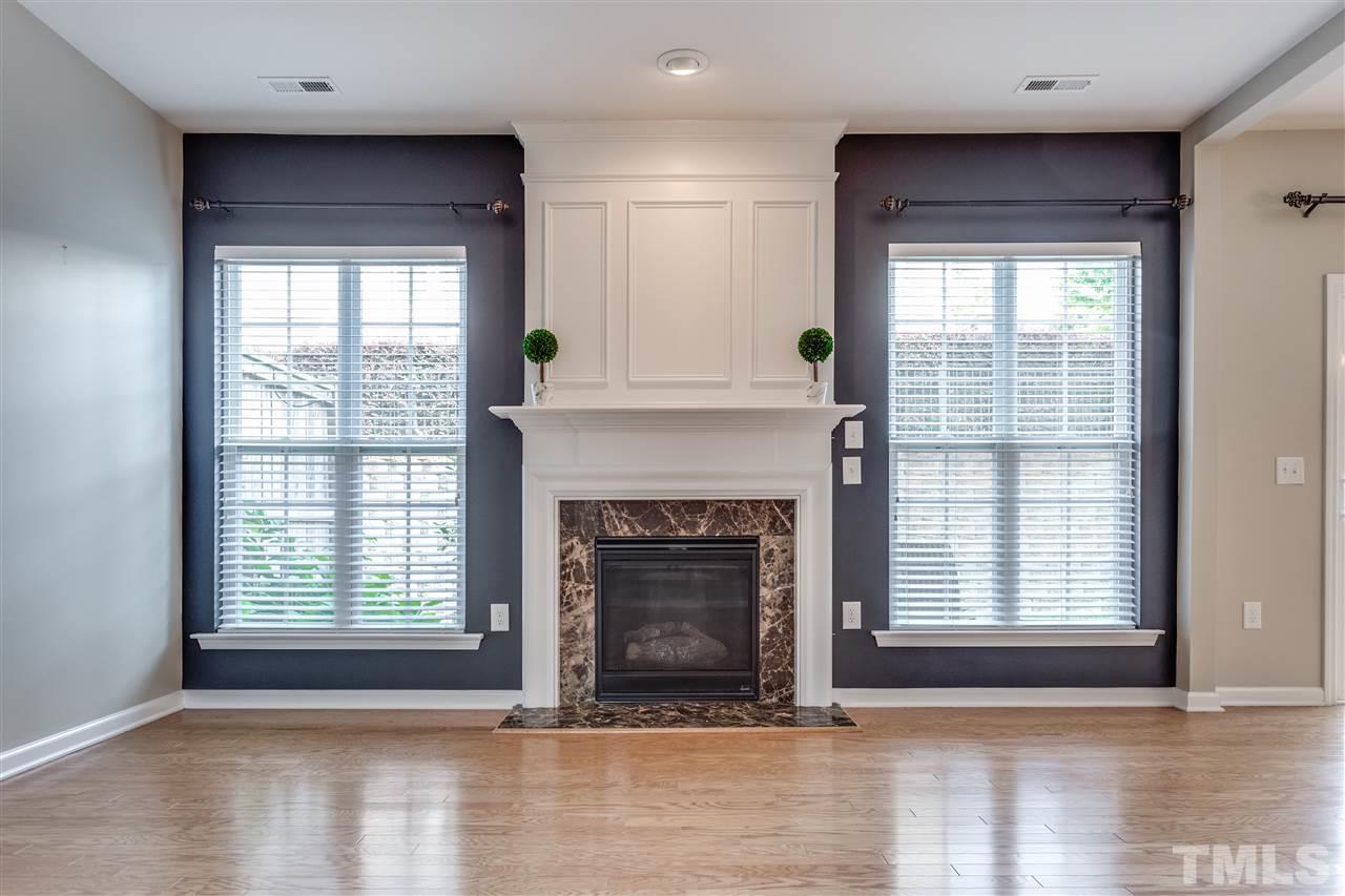 8702 Braxwood Place Raleigh, NC 27617 - Photo 5 of 24 a view of an empty room with wooden floor and a window