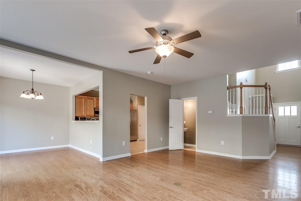 8702 Braxwood Place Raleigh, NC 27617 - Photo 6 of 24 a view of an empty room with wooden floor and a window