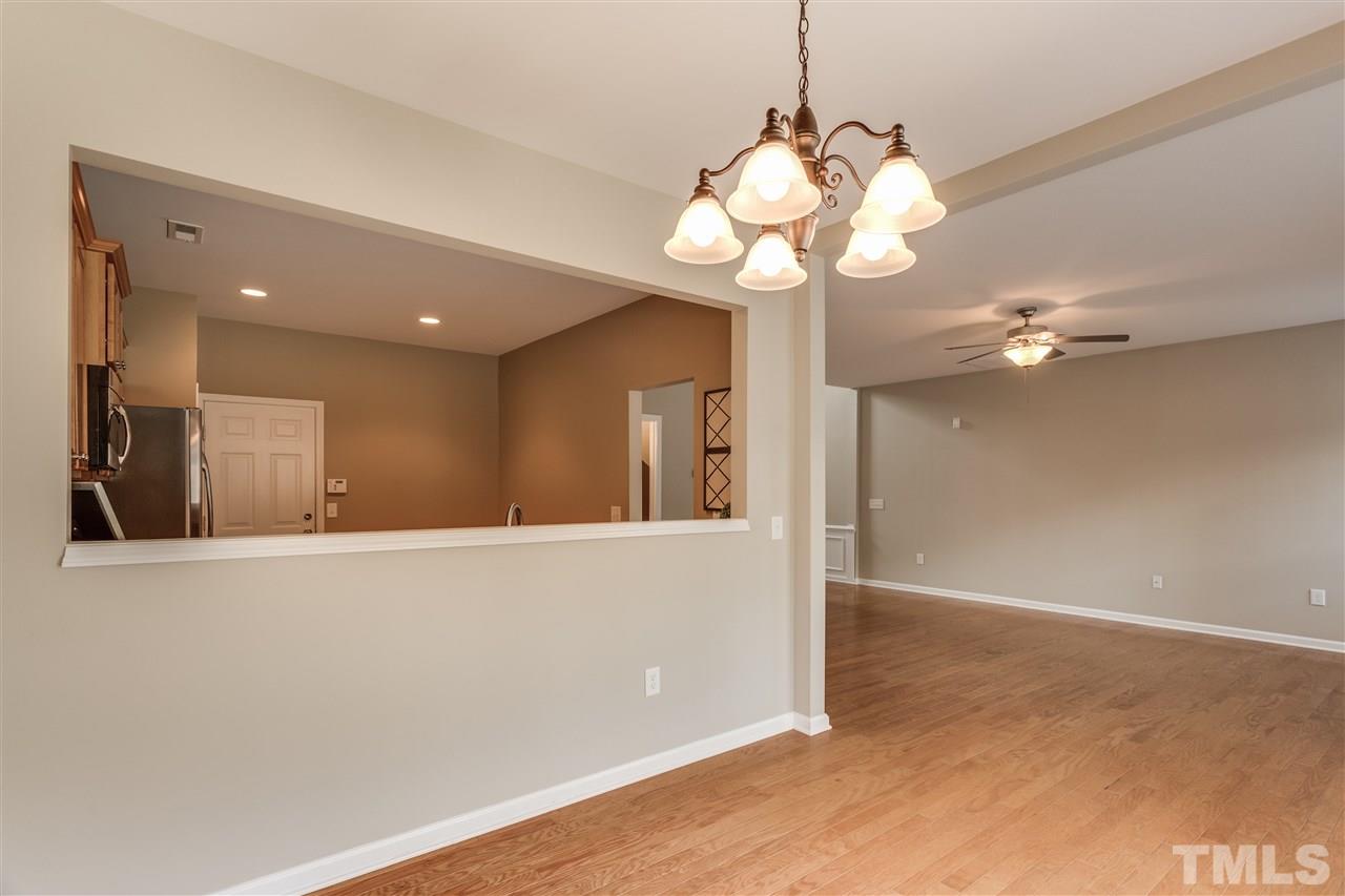 8702 Braxwood Place Raleigh, NC 27617 - Photo 7 of 24 a view of a hallway with chandelier