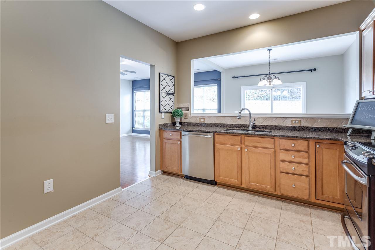 8702 Braxwood Place Raleigh, NC 27617 - Photo 9 of 24 a kitchen with granite countertop a sink and cabinets