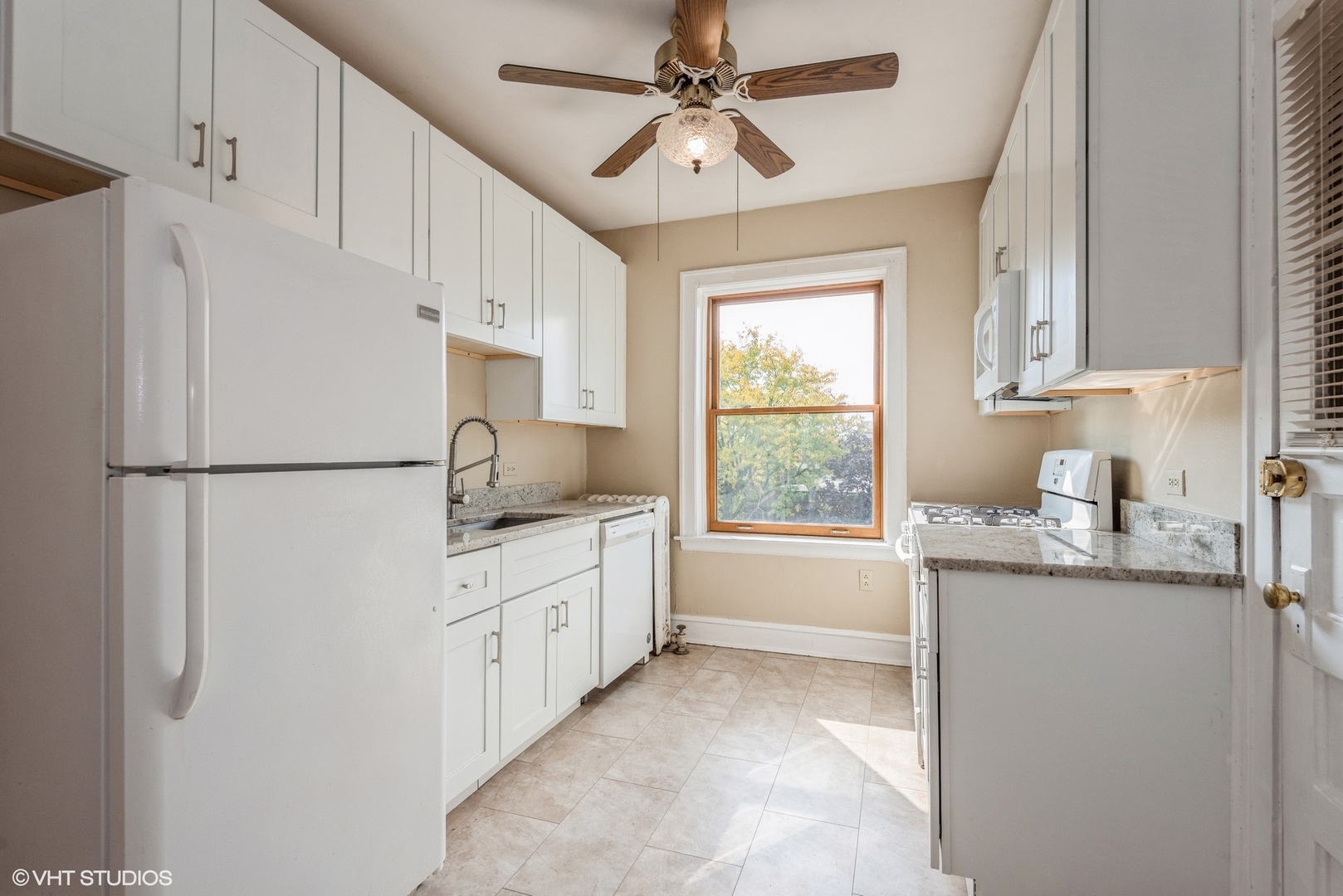 522 Sheridan Road, Unit 3A Evanston, IL 60202 - Photo 12 of 16 a kitchen with granite countertop a sink cabinets stainless steel appliances and a window