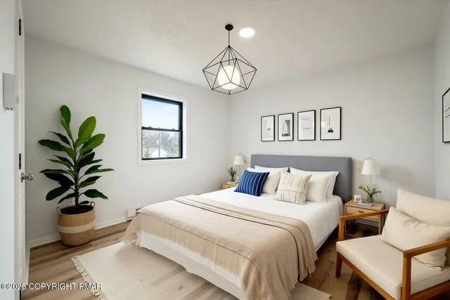 a bedroom with bed and a chandelier