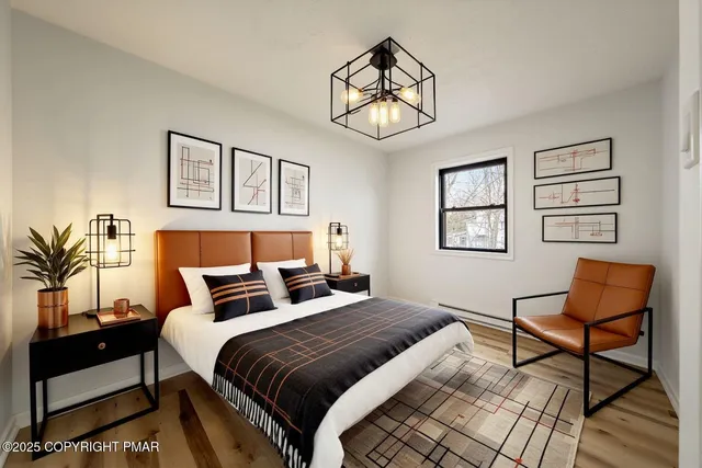 a bedroom with a bed and a chandelier