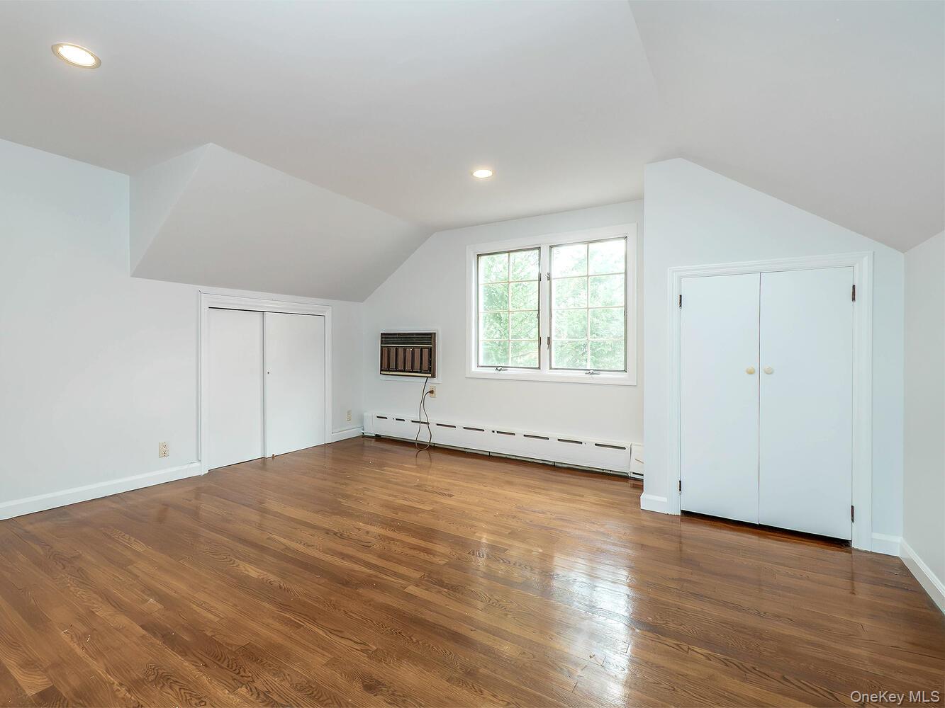 41 South 4th Street Locust Valley, NY 11560 - Photo 26 of 39 Bonus room with a baseboard radiator, wood finished floors, recessed lighting, an AC wall unit, and vaulted ceiling