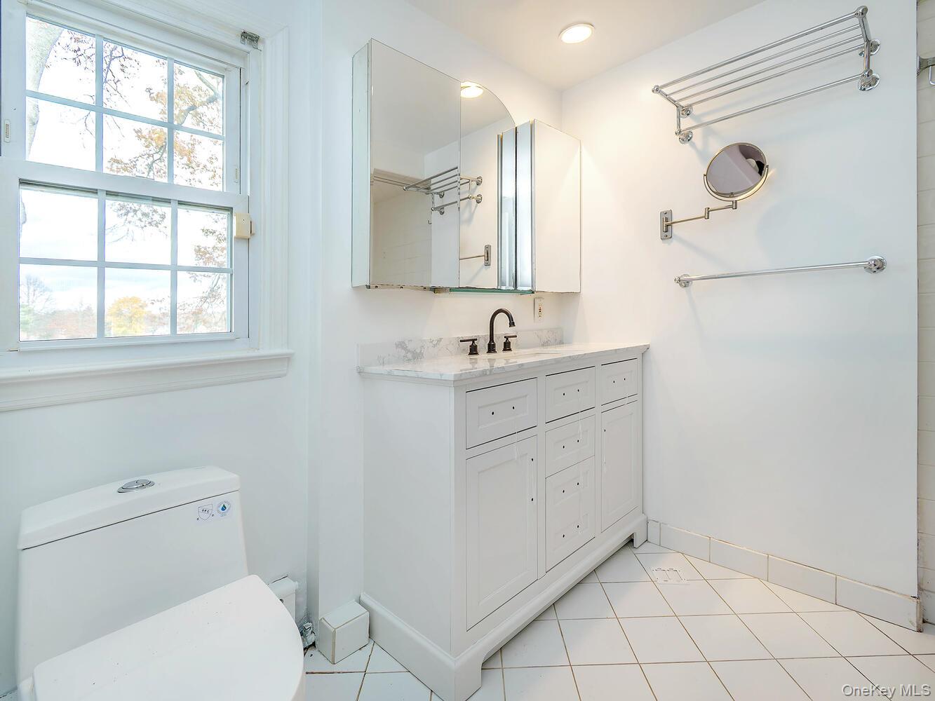 41 South 4th Street Locust Valley, NY 11560 - Photo 27 of 39 Bathroom featuring light tile patterned floors and vanity