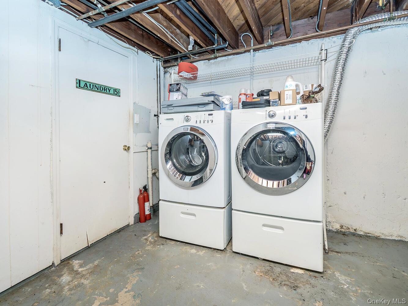 41 South 4th Street Locust Valley, NY 11560 - Photo 28 of 39 Laundry room featuring concrete flooring and washer and dryer