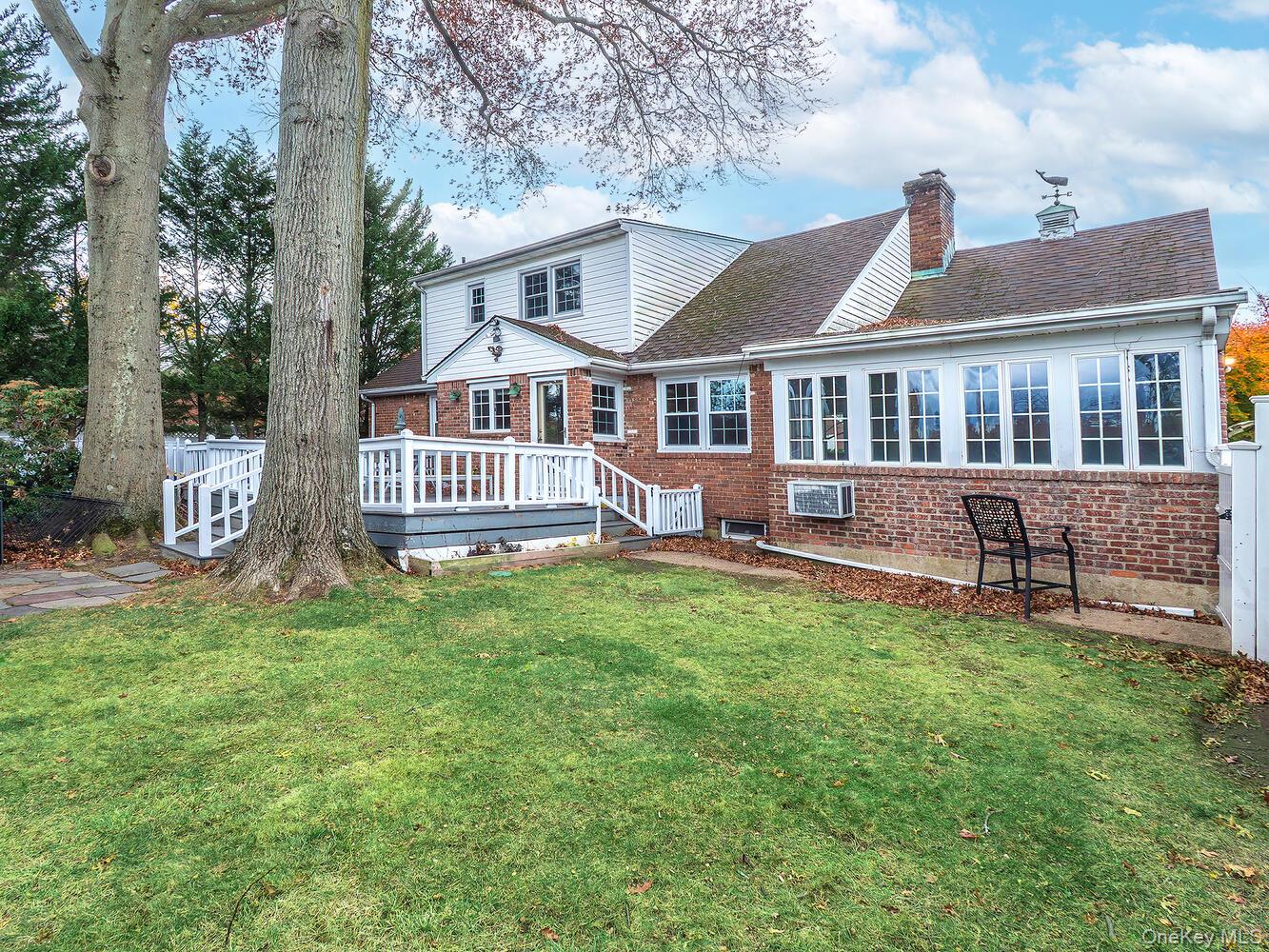 41 South 4th Street Locust Valley, NY 11560 - Photo 35 of 39 Back of house with a lawn, deck and pool