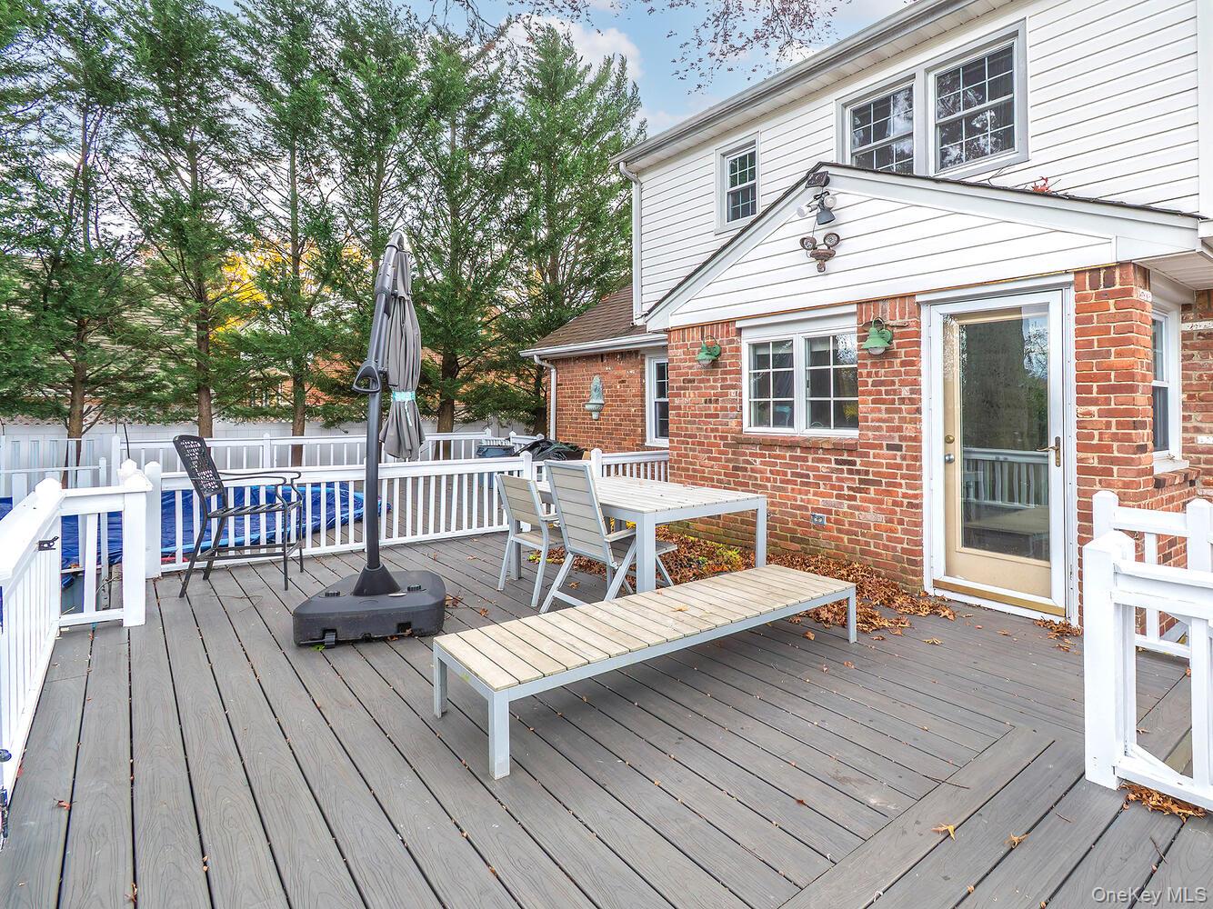 41 South 4th Street Locust Valley, NY 11560 - Photo 36 of 39 Deck with outdoor dining area and a fenced backyard