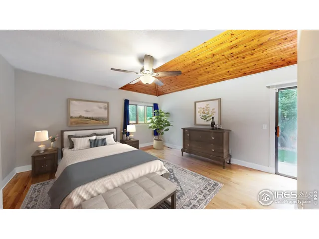 a living room with a bed furniture and a flat screen tv