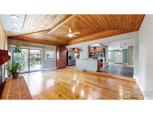 a room with lots of furniture and a potted plant