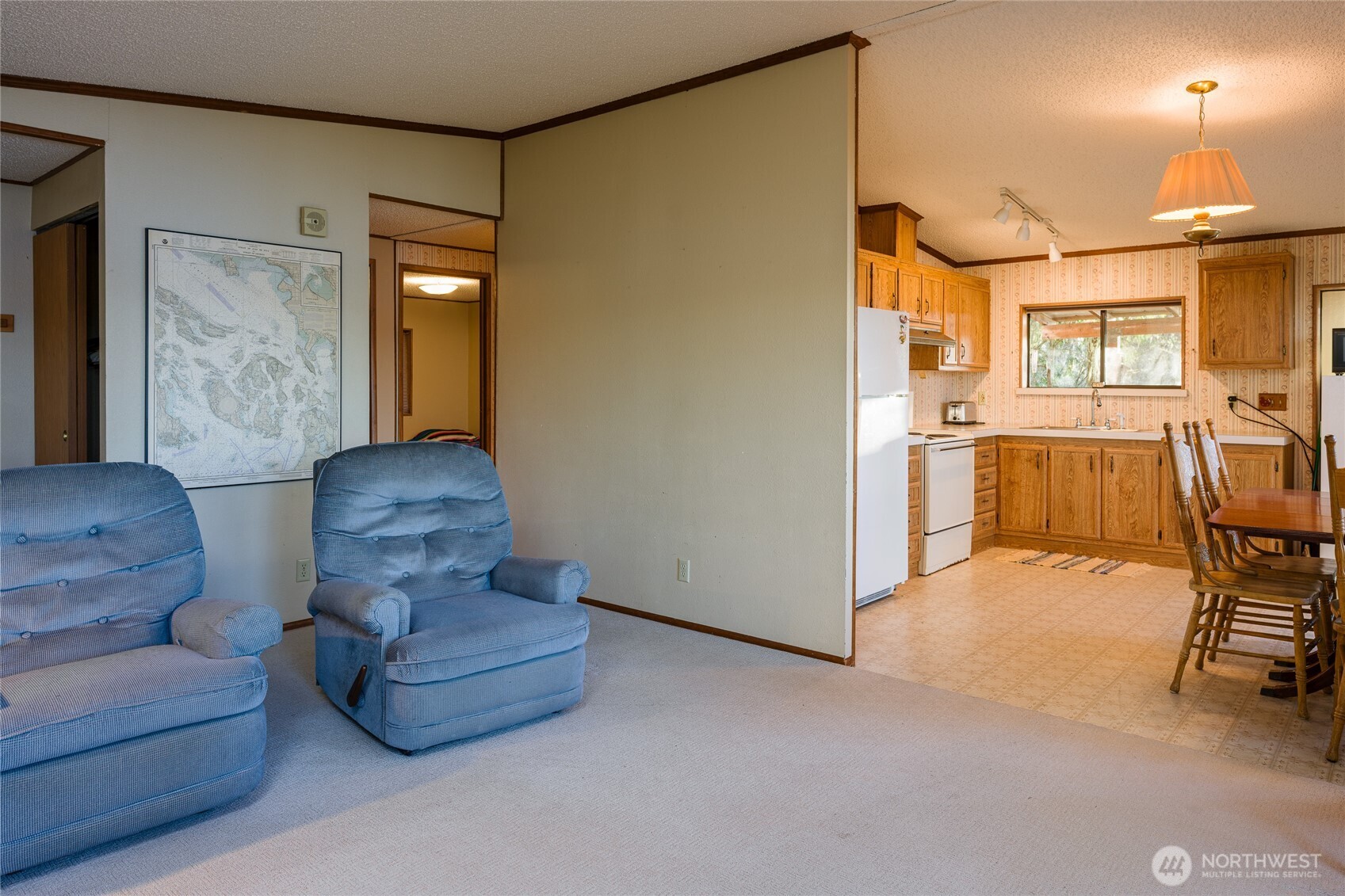 385 Doe Run Road Lopez Island, WA 98261 - Photo 15 of 31 a living room with furniture and a chandelier