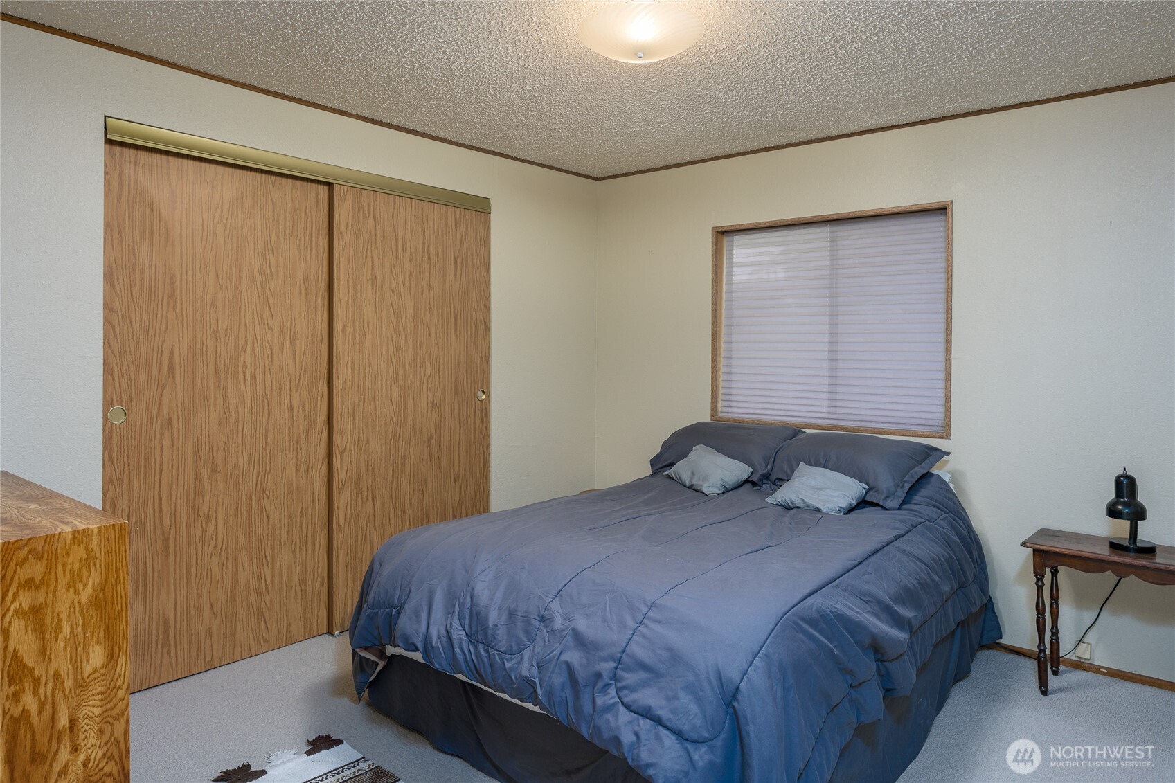 385 Doe Run Road Lopez Island, WA 98261 - Photo 19 of 31 a bedroom with a bed and a window