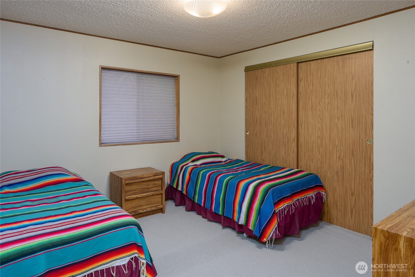 385 Doe Run Road Lopez Island, WA 98261 - Photo 20 of 31 a living room with a bed and lamp