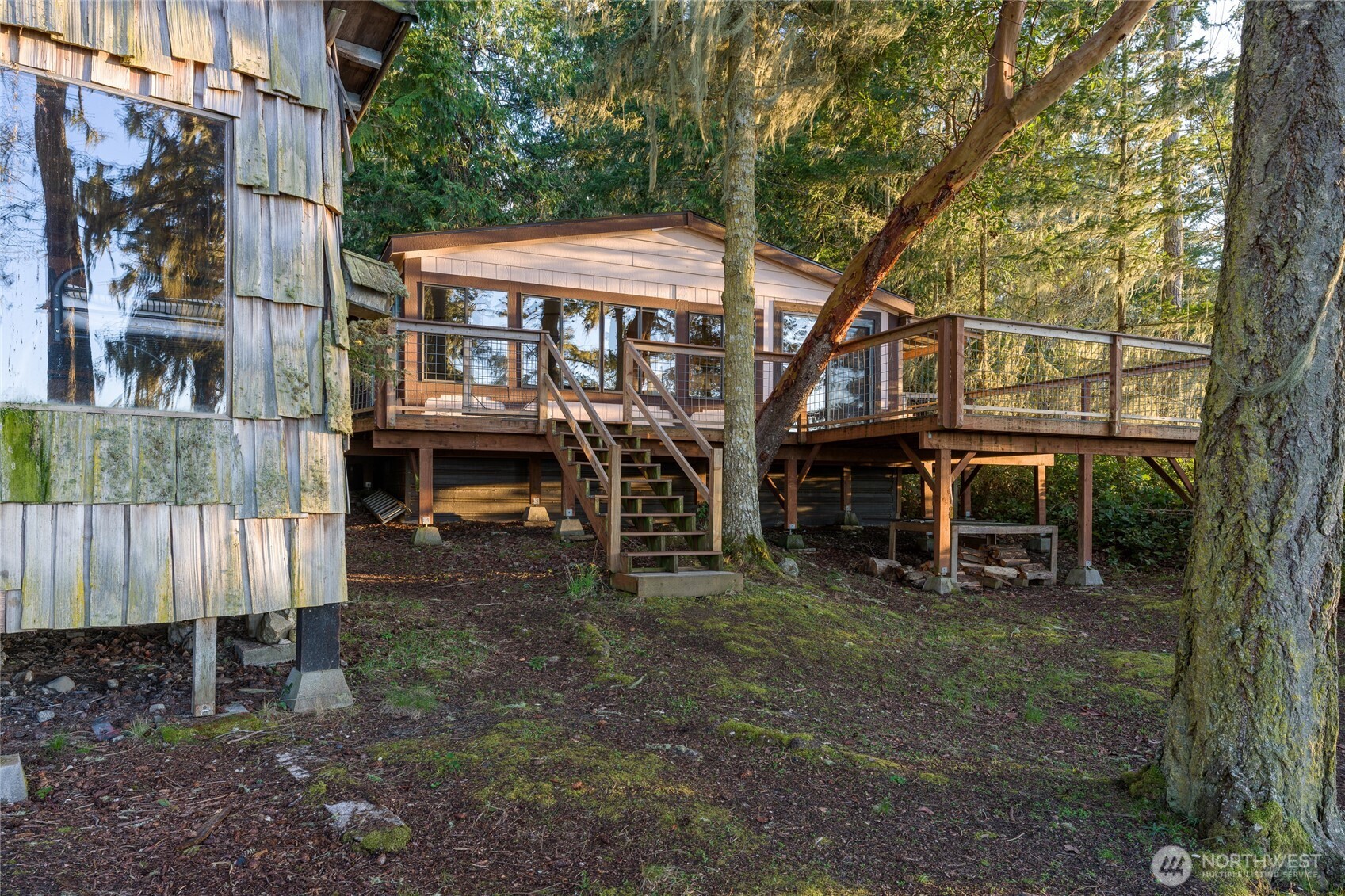 385 Doe Run Road Lopez Island, WA 98261 - Photo 24 of 31 a view of a house with a yard table and chairs