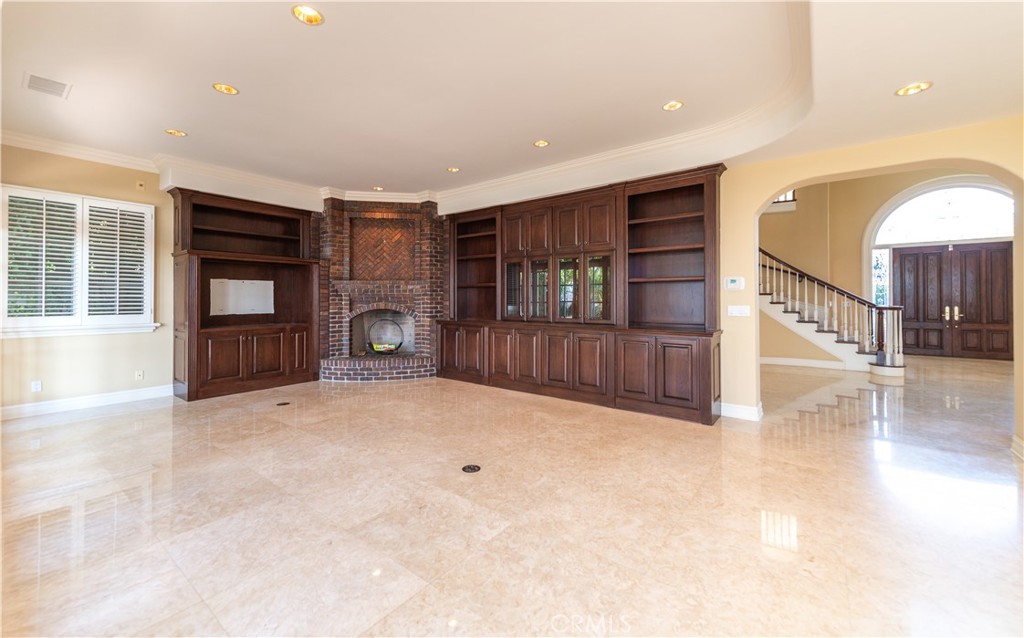 5 Sunpeak Irvine, CA 92603 - Photo 11 of 42 a view of an entryway with wooden floor fireplace and windows