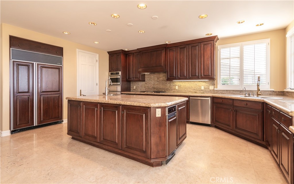 5 Sunpeak Irvine, CA 92603 - Photo 14 of 42 a kitchen with a sink stove and cabinets