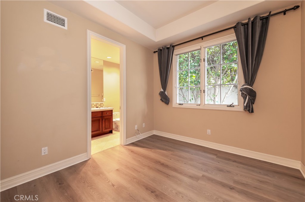 5 Sunpeak Irvine, CA 92603 - Photo 21 of 42 an empty room with wooden floor and windows