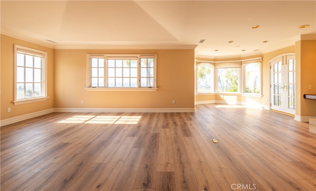 5 Sunpeak Irvine, CA 92603 - Photo 25 of 42 an empty room with wooden floor and windows