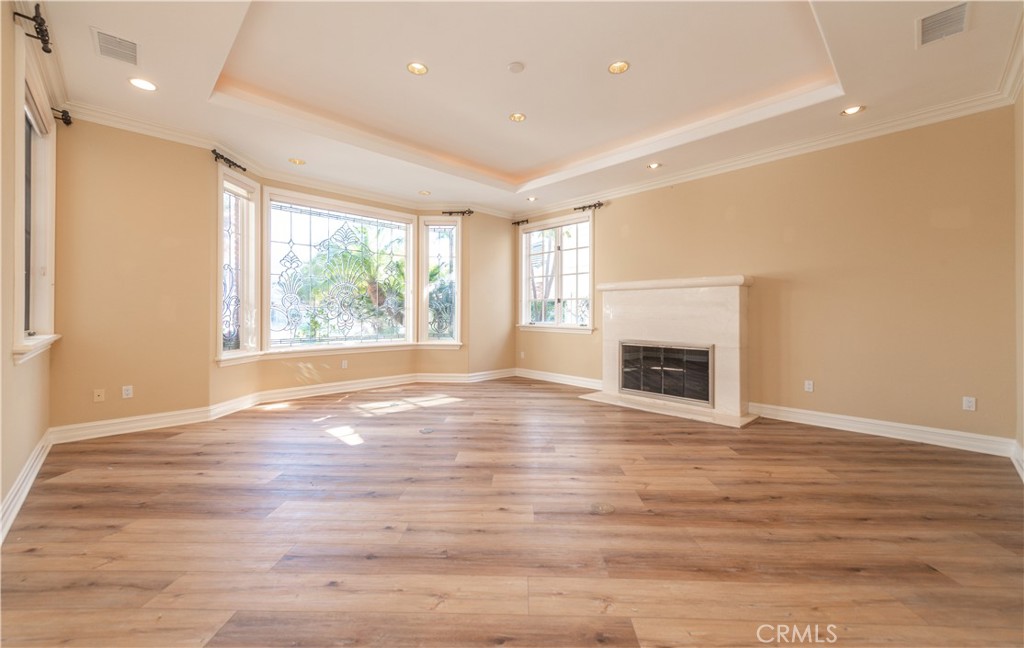 5 Sunpeak Irvine, CA 92603 - Photo 6 of 42 a view of an empty room with wooden floor and a window