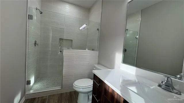 a bathroom with a sink a toilet and shower