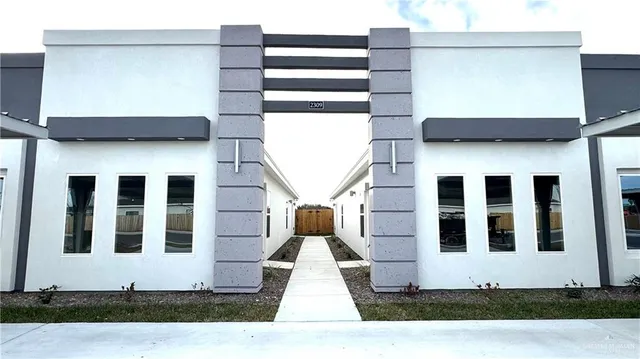 a front view of a building with a yard