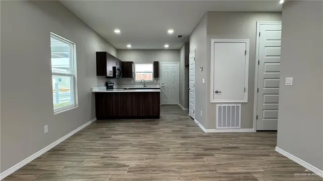 a view of kitchen with sink and window