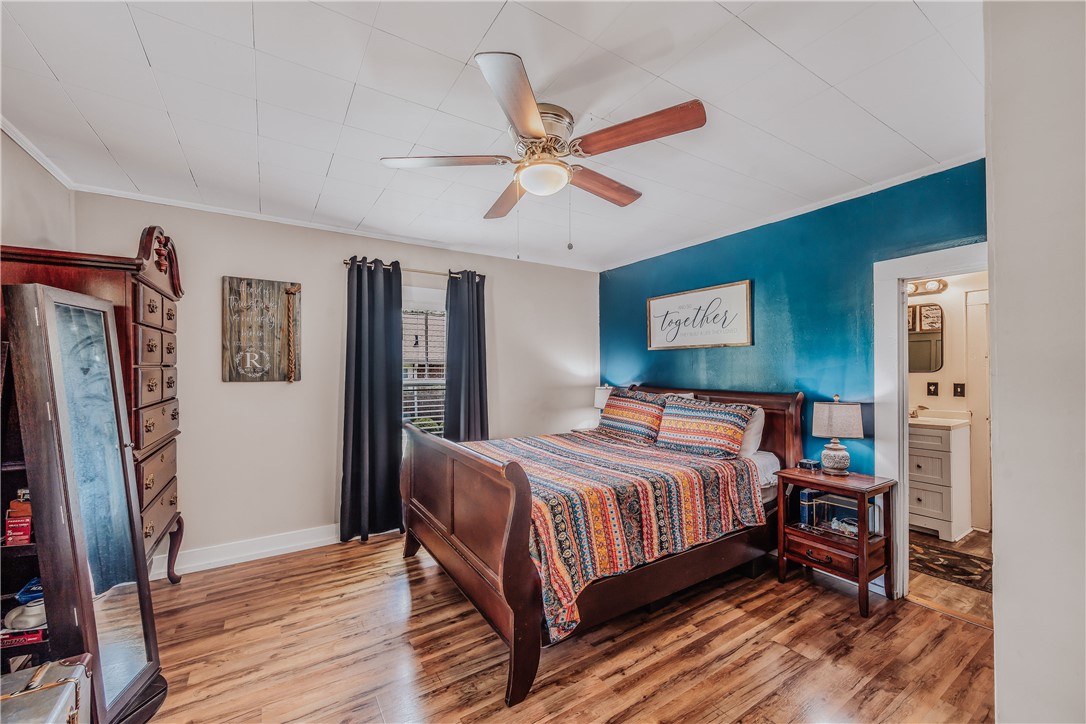 310 North Chestnut Street Seneca, SC 29678 - Photo 15 of 30 Vinyl flooring extends throughout this naturally illuminated bedroom with a ceiling fan.