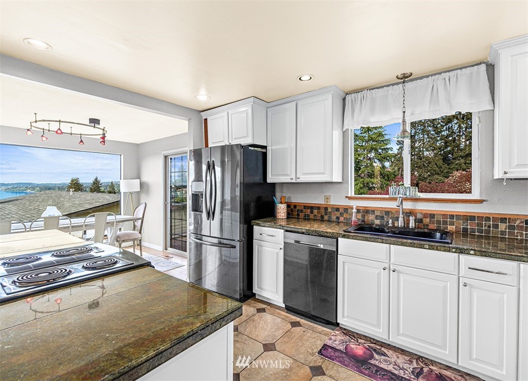 30002 2nd Avenue Southwest Federal Way, WA 98023 - Photo 12 of 34 a kitchen with stainless steel appliances granite countertop a sink stove and refrigerator