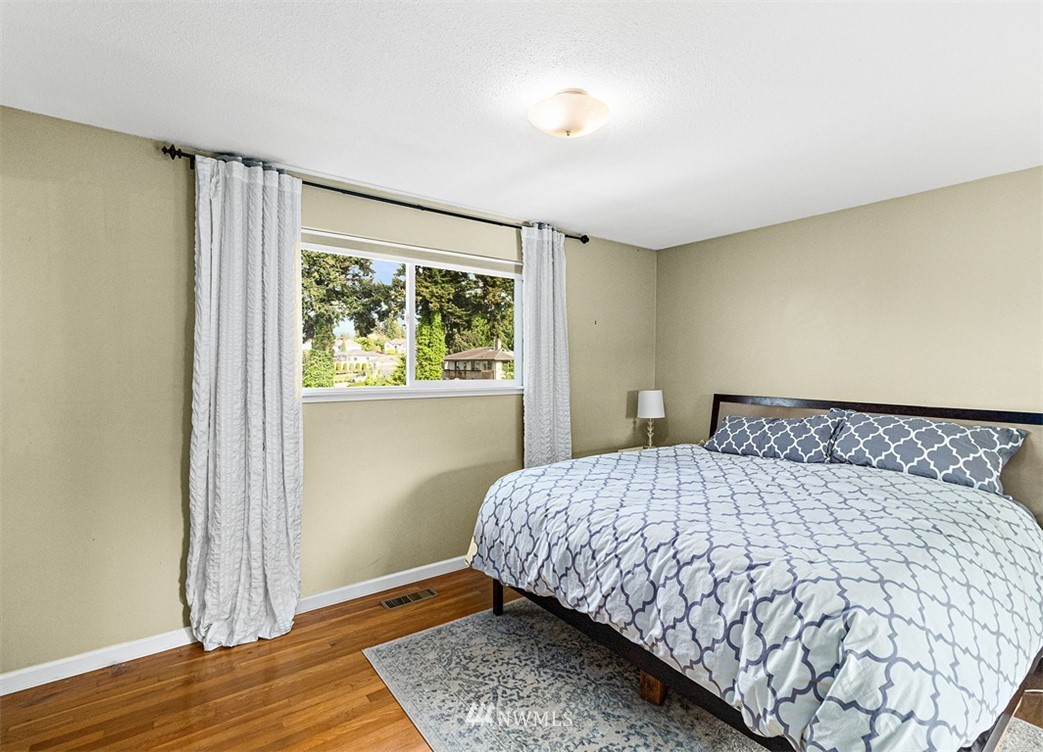 30002 2nd Avenue Southwest Federal Way, WA 98023 - Photo 15 of 34 a bedroom with a bed and wooden floor
