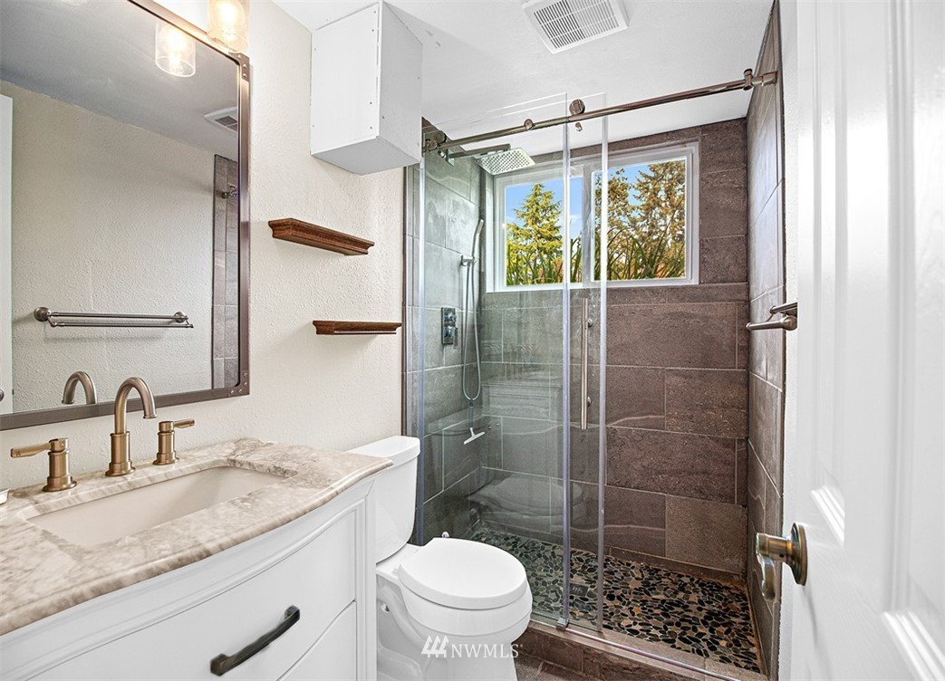 30002 2nd Avenue Southwest Federal Way, WA 98023 - Photo 23 of 34 a bathroom with a granite countertop sink a toilet and shower