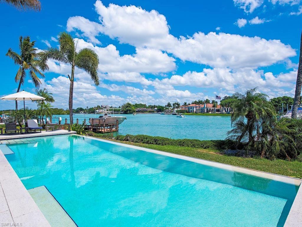 4253 Cutlass Lane Naples, FL 34102 - Photo 13 of 47 a view of a swimming pool and a yard
