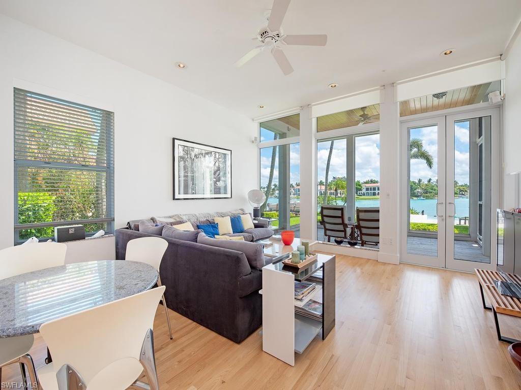 4253 Cutlass Lane Naples, FL 34102 - Photo 31 of 47 a living room with furniture and floor to ceiling windows