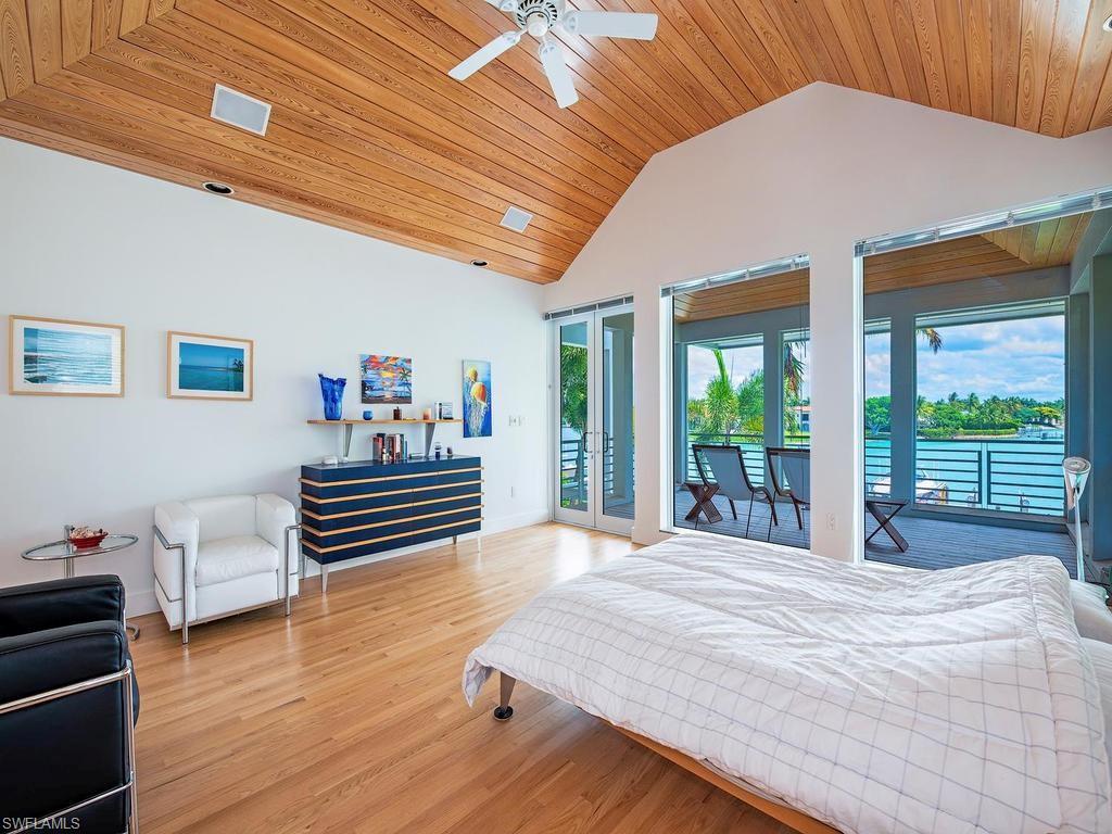 4253 Cutlass Lane Naples, FL 34102 - Photo 35 of 47 a bedroom with furniture and wooden floor