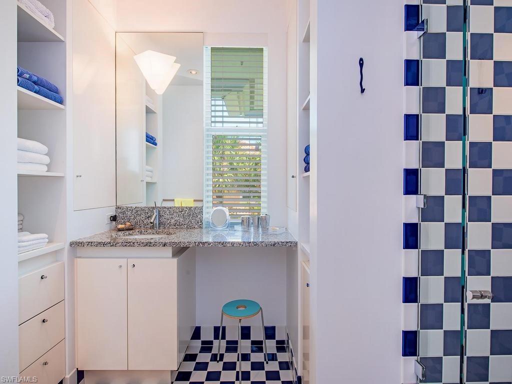 4253 Cutlass Lane Naples, FL 34102 - Photo 36 of 47 a bathroom with a sink a vanity and a mirror