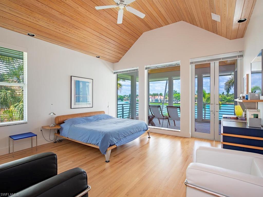 4253 Cutlass Lane Naples, FL 34102 - Photo 39 of 47 a bedroom with bed and wooden floor