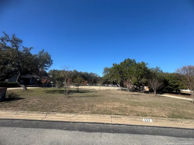 a view of dirt yard with a trampoline