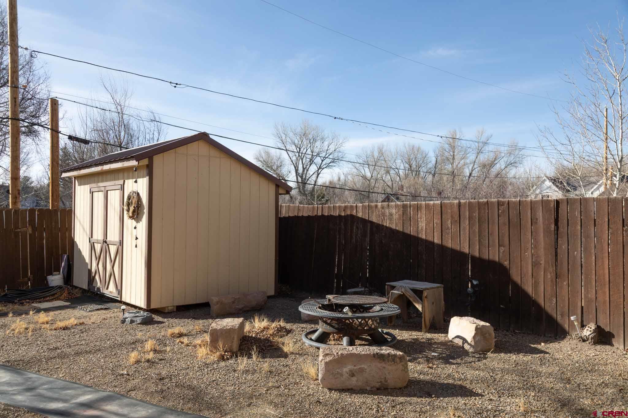 711 First Street Alamosa, CO 81101 - Photo 13 of 21 a backyard of a house with table and chairs
