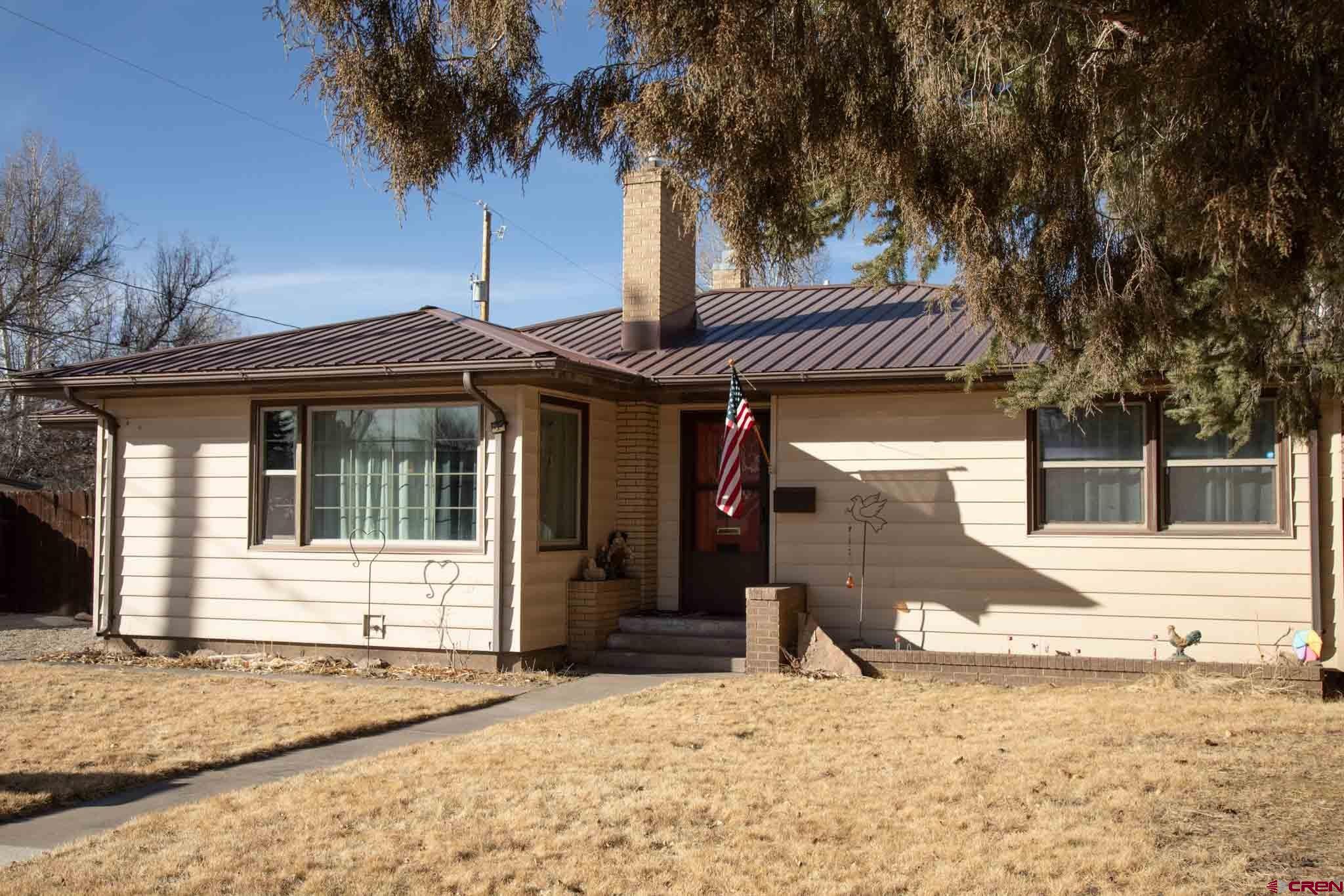 711 First Street Alamosa, CO 81101 - Photo 14 of 21 a front view of a house with a yard